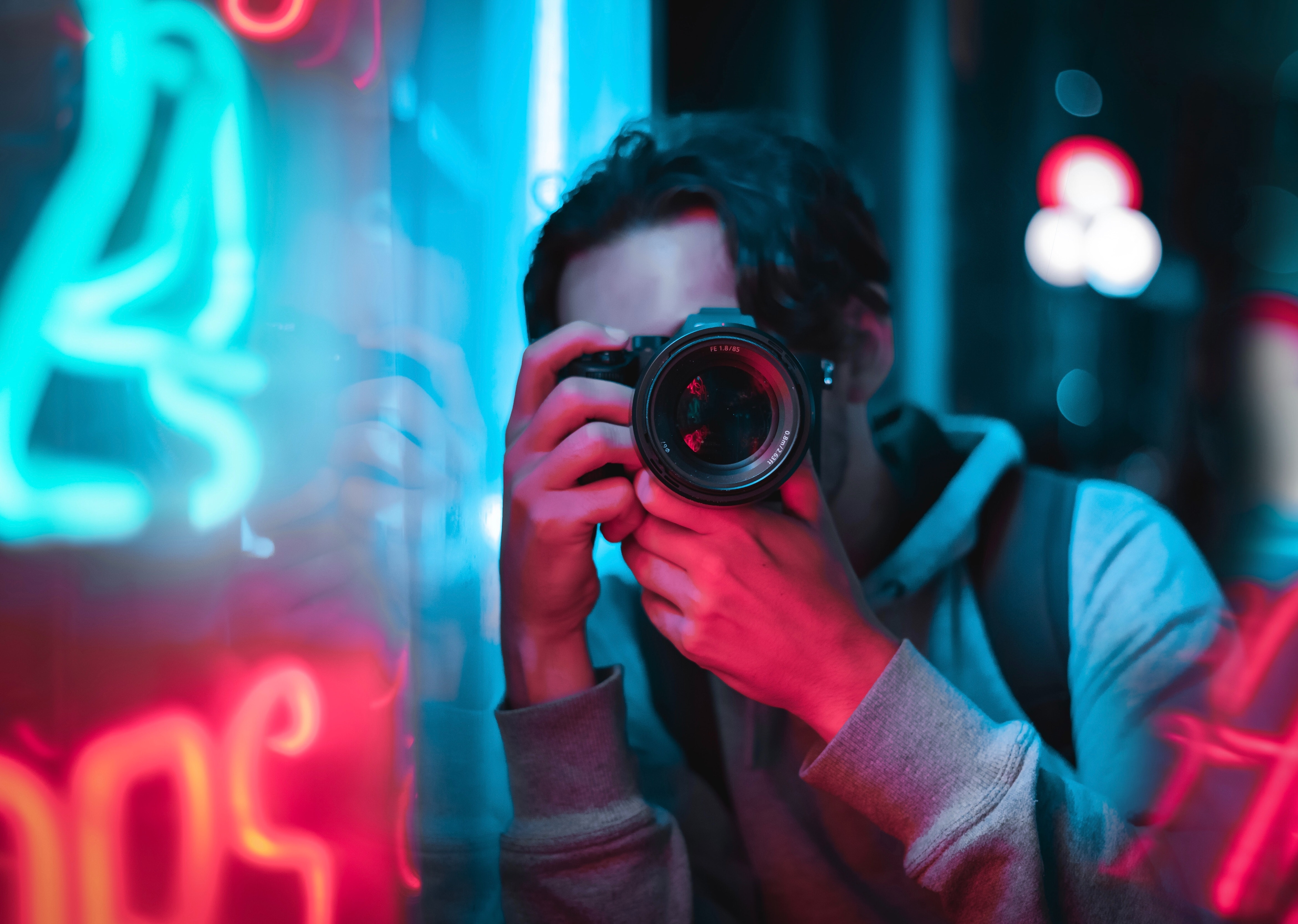 a photographer holding a camera on his face